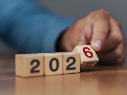 Business strategy and goals for 2026. Planning. Start of the new year. Businessman flips wooden blocks to change from 2025 to 2026.