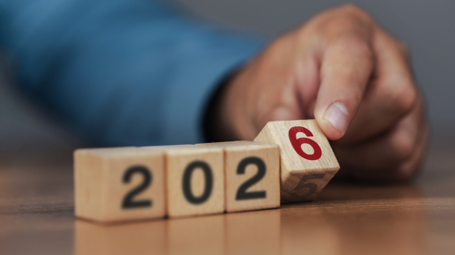Business strategy and goals for 2026. Planning. Start of the new year. Businessman flips wooden blocks to change from 2025 to 2026.